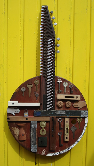 An unstrung instrument with many different keys  - mixed media construction